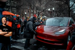Musk grinning as protester vandalizes Tesla
